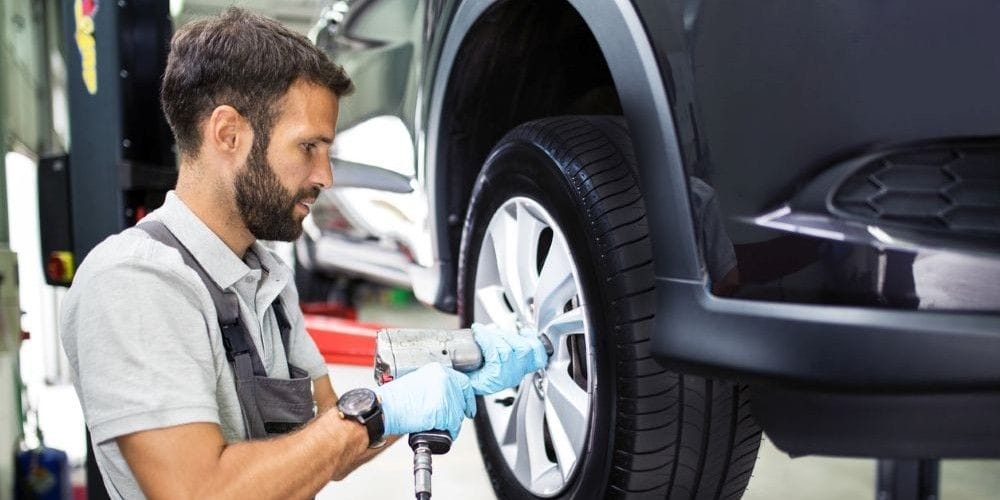 Mechanic replacing the tires on a car.