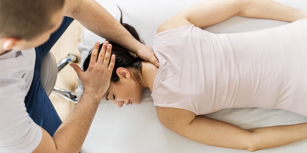Chiropractor giving a woman an adjustment.