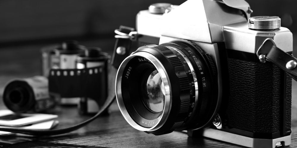 Vintage 35mm film camera in black and white monochrome.